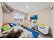 A fun bedroom with playful decor, a window seat, a desk, and a closet at 12545 Elm St, Thornton, CO 80241