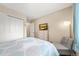 Comfortable bedroom features a large window, an accent chair, and a closet for ample storage space at 12545 Elm St, Thornton, CO 80241