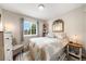 Cozy bedroom with large window, soft natural light, and neutral decor, creating a peaceful atmosphere at 12545 Elm St, Thornton, CO 80241