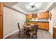 Cozy dining area featuring a round wooden table, four chairs, wooden floors, and complementary wooden cabinets at 12545 Elm St, Thornton, CO 80241