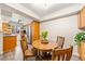 Cozy kitchen nook with room for a round wooden table and seating, complemented by wooden cabinets and natural light at 12545 Elm St, Thornton, CO 80241