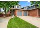 Two-story home with brick and siding exterior, a well-manicured lawn, and a two-car garage at 12545 Elm St, Thornton, CO 80241