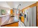 Functional kitchen featuring wooden cabinetry, granite countertops, stainless steel appliances, and natural lighting at 12545 Elm St, Thornton, CO 80241