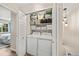Laundry room with a washer and dryer, a storage shelf, and a bright aesthetic at 12545 Elm St, Thornton, CO 80241