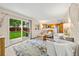 Open-concept living room seamlessly connects to the kitchen with a large sliding glass door to the backyard at 12545 Elm St, Thornton, CO 80241