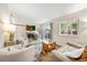Cozy living room features a fireplace, mantle-mounted TV, ample seating, and natural light from the sliding glass door at 12545 Elm St, Thornton, CO 80241