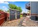 Storage shed with a painted tree and bird design located in a well-kept backyard at 12545 Elm St, Thornton, CO 80241