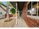 Inviting walkway featuring brick siding and a view of the front door, complemented by mature trees and lush greenery at 12545 Elm St, Thornton, CO 80241