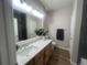 Bathroom with dual vanity, a large mirror, and sleek fixtures at 14400 Albrook Dr # 88, Denver, CO 80239