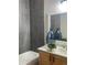 Bathroom featuring modern gray tile shower with bathtub, vanity and decorative plant at 14400 Albrook Dr # 88, Denver, CO 80239