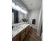 Modern bathroom with dual vanity, a large mirror, and sleek fixtures at 14400 Albrook Dr # 88, Denver, CO 80239