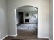 Inviting living room with hardwood floors, an archway, and a stone fireplace at 14400 Albrook Dr # 88, Denver, CO 80239