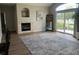 Cozy living room featuring a fireplace, vaulted ceiling, and sliding glass door at 14400 Albrook Dr # 88, Denver, CO 80239
