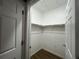 Walk-in closet with ample shelving and lighting for efficient storage at 14400 Albrook Dr # 88, Denver, CO 80239