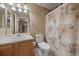 Bathroom features a vanity with sink, toilet, and a shower/tub with a decorative shower curtain at 22873 E David Pl, Aurora, CO 80016