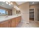 Bright bathroom featuring double vanity sinks, tile flooring, and a separate shower at 22873 E David Pl, Aurora, CO 80016