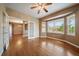 Comfortable bedroom with hardwood floors, bay window, ceiling fan, and adjoining room at 22873 E David Pl, Aurora, CO 80016
