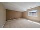 Neutral bedroom with a large window that provides plenty of natural light and carpet flooring at 22873 E David Pl, Aurora, CO 80016