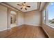 Primary bedroom suite with wood floors, tray ceiling, ensuite bathroom, and large windows at 22873 E David Pl, Aurora, CO 80016