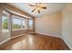 Inviting bedroom with large windows, hardwood floors, and ceiling fan providing comfort at 22873 E David Pl, Aurora, CO 80016