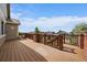 Expansive wooden deck with railings, brick supports, and an amazing view at 22873 E David Pl, Aurora, CO 80016