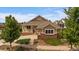 Charming single-Gathering home with a brick foundation, covered porch, and well-manicured landscaping at 22873 E David Pl, Aurora, CO 80016