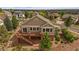 Aerial view of home showcasing a large deck, meticulous landscaping, and mature trees at 22873 E David Pl, Aurora, CO 80016