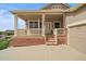Close up image of the home's welcoming front porch with a brick foundation and decorative columns at 22873 E David Pl, Aurora, CO 80016