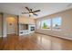 Cozy living room featuring hardwood floors, a fireplace with built-ins, and large bright windows at 22873 E David Pl, Aurora, CO 80016