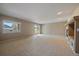 Bright living room featuring neutral paint, sliding glass doors, and a large window for natural light at 22873 E David Pl, Aurora, CO 80016