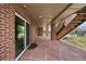 Covered brick patio with stone flooring, stairway, and sliding glass door at 22873 E David Pl, Aurora, CO 80016