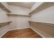 Spacious walk-in closet with wood floors and built-in shelving for ample storage space at 22873 E David Pl, Aurora, CO 80016