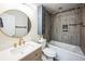 Renovated bathroom with modern vanity, stylish mirror, bathtub with shower, and tiled walls at 1250 S Monaco Pkwy # 44, Denver, CO 80224
