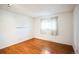 A cozy bedroom features hardwood floors, and a bright window with natural light at 1250 S Monaco Pkwy # 44, Denver, CO 80224