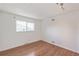 Cozy bedroom with hardwood floors, window providing natural light, and minimalist design at 1250 S Monaco Pkwy # 44, Denver, CO 80224