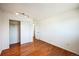 Spacious bedroom with hardwood flooring, closet, and white walls at 1250 S Monaco Pkwy # 44, Denver, CO 80224