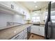 The remodeled kitchen offers granite countertops, stainless steel appliances, and white cabinetry at 1250 S Monaco Pkwy # 44, Denver, CO 80224