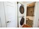 In-unit laundry and partial view of bathroom with shower and toilet at 1250 S Monaco Pkwy # 44, Denver, CO 80224