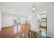 Bright living space with hardwood floors, French doors, and access to the kitchen at 1250 S Monaco Pkwy # 44, Denver, CO 80224