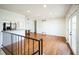 Spacious living room showcasing hardwood floors, access to the kitchen, and doors to the outside at 1250 S Monaco Pkwy # 44, Denver, CO 80224
