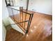 Stairwell leading to the basement with finished wood steps and black metal railing at 1250 S Monaco Pkwy # 44, Denver, CO 80224