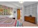 Comfortable bedroom with colorful quilt and ample storage at 708 Brome Pl, Lafayette, CO 80026