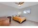 Well-lit bedroom features a ceiling fan, a large window, and neutral carpet at 708 Brome Pl, Lafayette, CO 80026