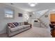 Comfortable living room with carpeted floors, neutral paint, and a staircase at 708 Brome Pl, Lafayette, CO 80026