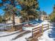 Long driveway leading to a house with a large garage and a wooden fence at 34989 Forest Park Dr, Elizabeth, CO 80107