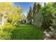 Expansive backyard featuring green lawn and mature trees at 3925 S Cherry St, Englewood, CO 80113