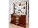 Modern bar area featuring wooden cabinetry, sleek lighting, and ample storage space for beverages at 3925 S Cherry St, Englewood, CO 80113