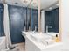 Elegant bathroom with blue tile walls, a vessel sink, and decorative vases at 3925 S Cherry St, Englewood, CO 80113