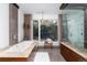 The bathroom features tile floors, a soaking tub and a walk-in shower at 3925 S Cherry St, Englewood, CO 80113