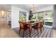 Elegant dining room with a large window, stylish chandelier, and seating for six at 3925 S Cherry St, Englewood, CO 80113
